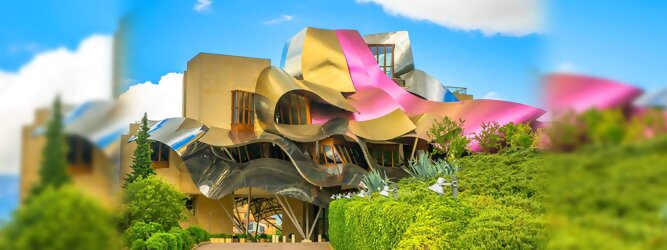 Trip Islands Reisetipps - Marqués de Riscal Design Hotel, Bilbao, Elciego, Spanien. Fantastisch galaktisch, unverkennbar ein Werk von Frank O. Gehry. Inmitten idyllischer Weinberge in der Rioja Region des Baskenlandes, bezaubert das schimmernde Bauobjekt mit einer Struktur bunter, edel glänzender verflochtener Metallbänder. Glanz im Baskenland - Es muss etwas ganz Besonderes sein. Emotional, zukunftsweisend, einzigartig. Denn in dieser Region, etwa 133 km südlich von Bilbao, sind Weingüter normalerweise nicht für die Öffentlichkeit zugänglich.